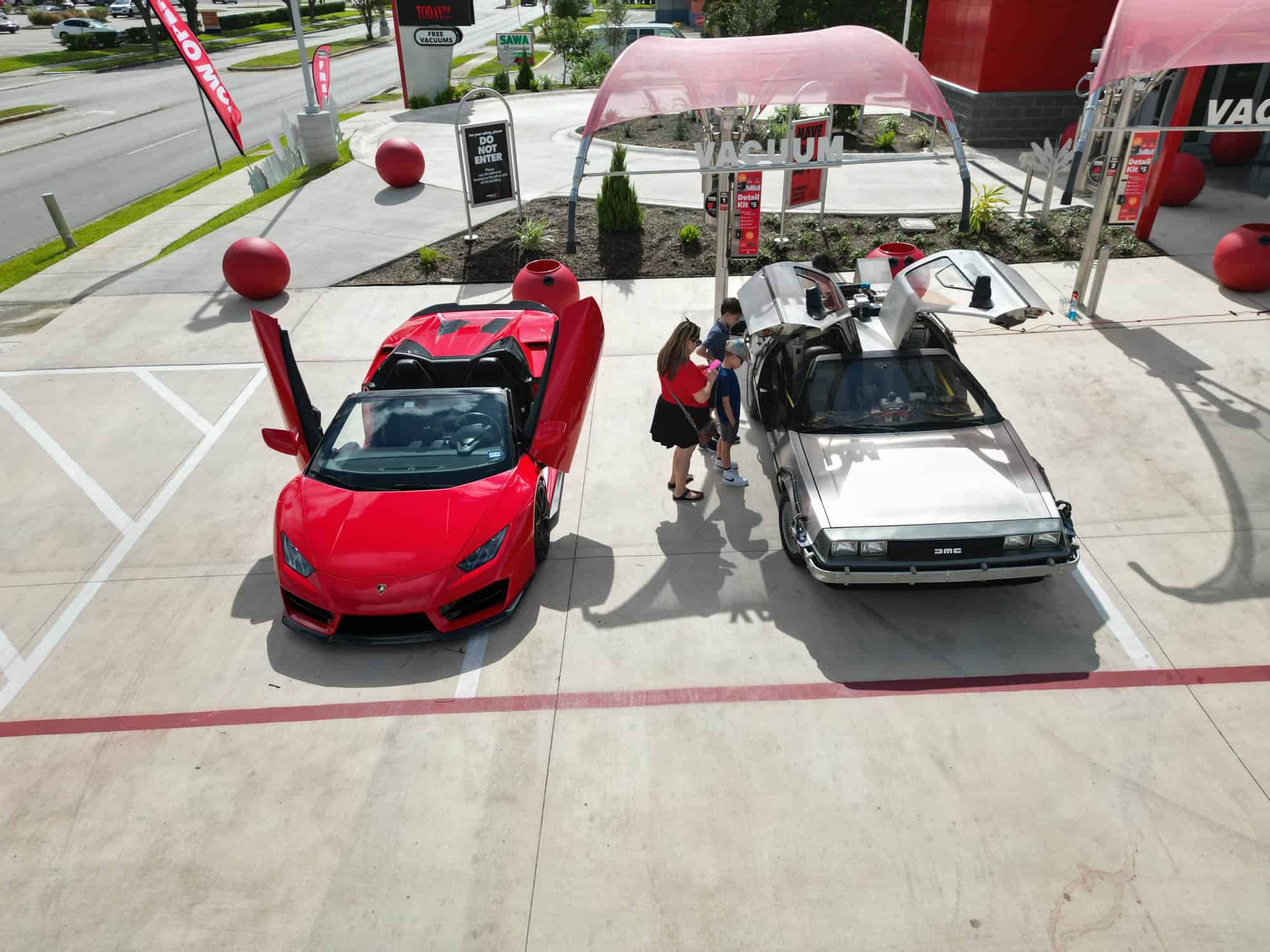 Two nice and clean cars parked at Tommy's Express Car Wash